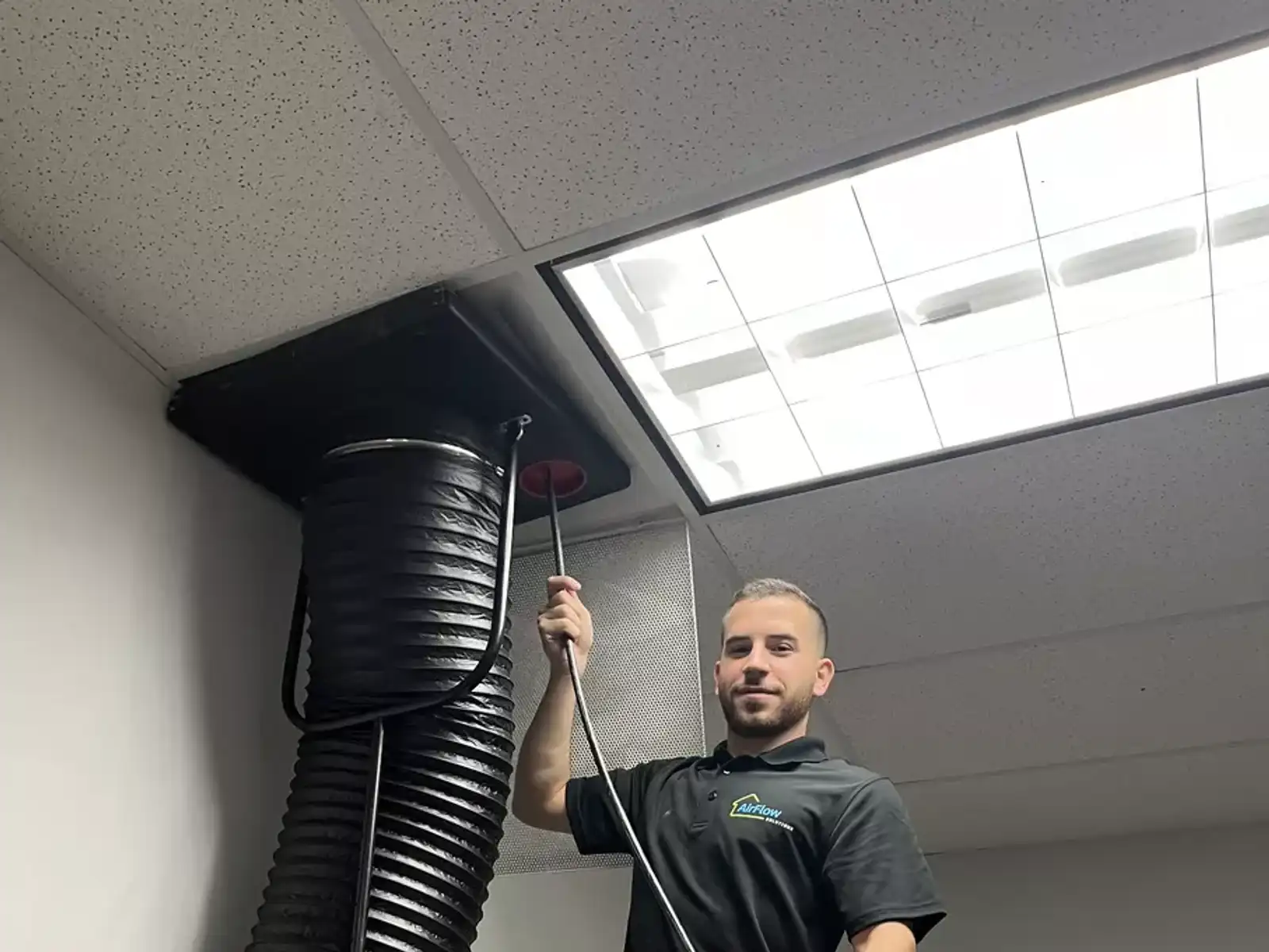 Technician working on air ducts
